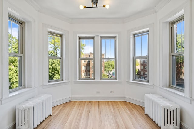 847 S Humphrey Ave Unit 3, Oak Park, IL 60304 - unfurnished sunroom with radiator heating unit, wood finished floors, a chandelier, and ornamental molding