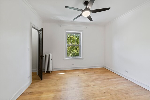847 S Humphrey Ave Unit 3, Oak Park, IL 60304 - spare room with radiator heating unit, light wood-style floors, crown molding, a ceiling fan, and baseboards