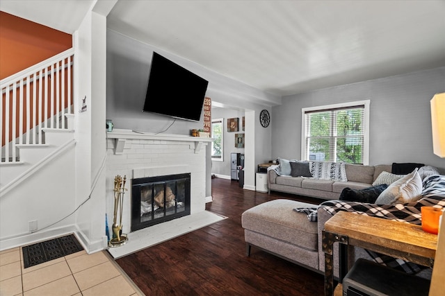 501 N 2nd Ave, Maywood, IL 60153 - living area featuring a fireplace, baseboards, wood finished floors, and stairway