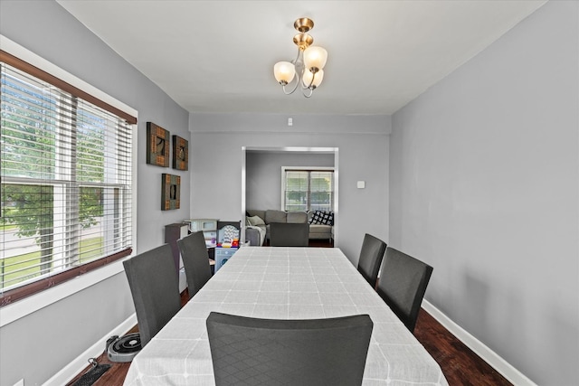 501 N 2nd Ave, Maywood, IL 60153 - dining space featuring a chandelier, dark wood-type flooring, and baseboards