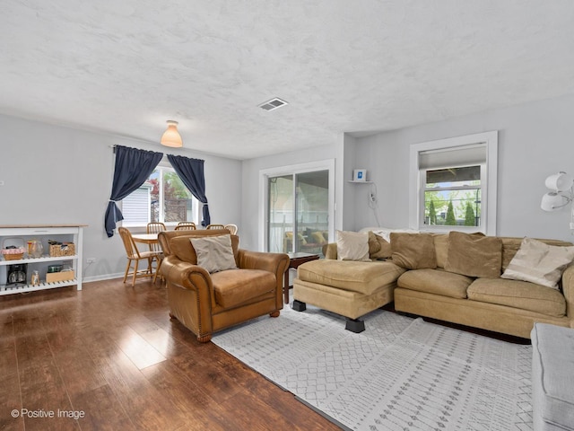 307 N Schubert St, Palatine, IL 60067 - living area with dark wood-style floors, healthy amount of natural light, and baseboards