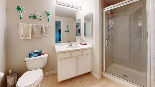 701 W Rand Rd Unit 227, Arlington Heights, IL 60004 - bathroom with tile patterned floors, a stall shower, vanity, toilet, and baseboards