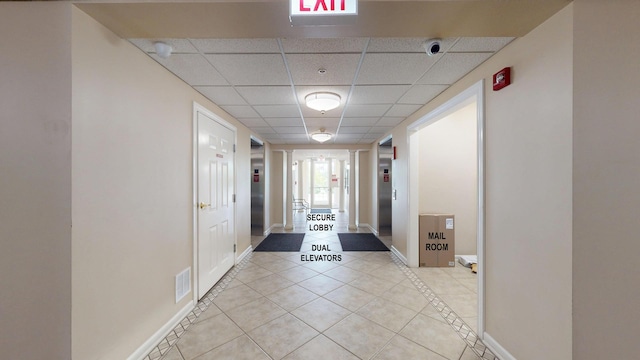 701 W Rand Rd Unit 227, Arlington Heights, IL 60004 - hall with light tile patterned flooring, a drop ceiling, and baseboards