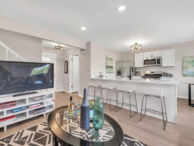 729 Bolton Way, Hanover Park, IL 60133 - living area featuring light wood-style flooring, baseboards, and recessed lighting