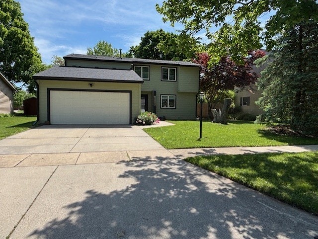 2112 Mayfair Rd, Champaign, IL 61821 - view of front of home featuring an attached garage, a front yard, and concrete driveway