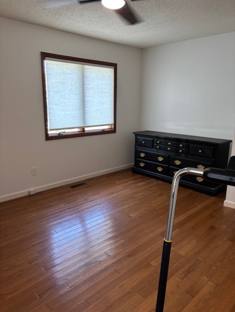 2112 Mayfair Rd, Champaign, IL 61821 - empty room featuring wood finished floors, baseboards, a ceiling fan, and a textured ceiling