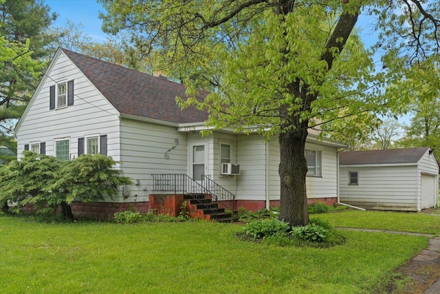 37519 N N Ave, Beach Park, IL 60087 - view of front of property featuring a front yard, a shingled roof, cooling unit, and an outbuilding