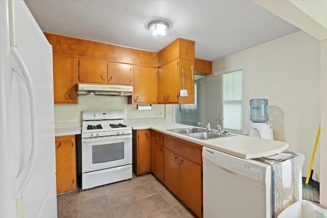 37519 N N Ave, Beach Park, IL 60087 - kitchen featuring white appliances, under cabinet range hood, a sink, light countertops, and brown cabinets