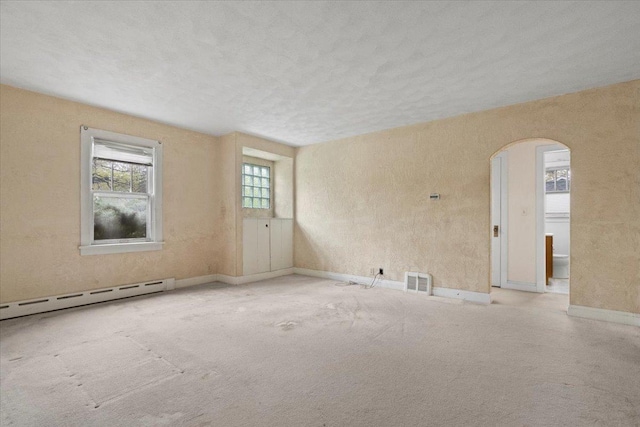 37519 N N Ave, Beach Park, IL 60087 - carpeted empty room with a baseboard heating unit, arched walkways, and baseboards