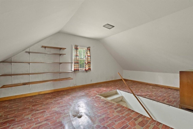 37519 N N Ave, Beach Park, IL 60087 - additional living space with vaulted ceiling, baseboards, and brick patterned floors