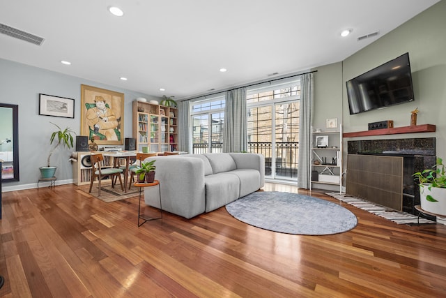 2207 N Western Ave Unit 2C, Chicago, IL 60647 - living area featuring a fireplace, wood finished floors, a desk, and recessed lighting