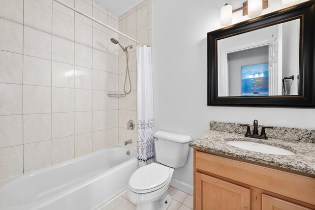 2207 N Western Ave Unit 2C, Chicago, IL 60647 - bathroom featuring vanity, shower / bath combo with shower curtain, toilet, baseboards, and tile patterned floors