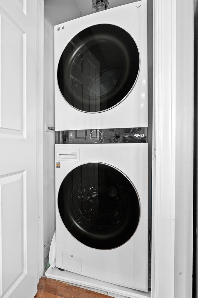 2207 N Western Ave Unit 2C, Chicago, IL 60647 - laundry area with stacked washer / dryer and wood finished floors