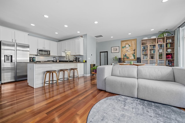 2207 N Western Ave Unit 2C, Chicago, IL 60647 - living room with dark wood-style flooring, recessed lighting, and baseboards