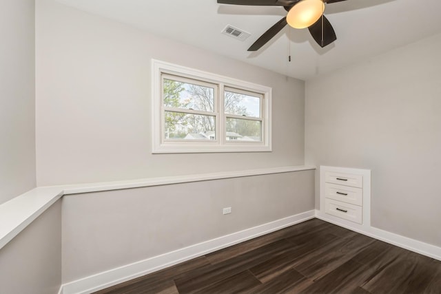9104 Oriole Trl, Wonder Lake, IL 60097 - spare room featuring dark wood finished floors, baseboards, and ceiling fan