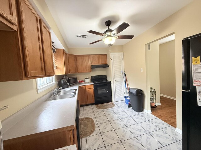 22633 Pleasant Dr Unit 11B, Richton Park, IL 60471 - kitchen with black appliances, a sink, under cabinet range hood, brown cabinetry, and a ceiling fan