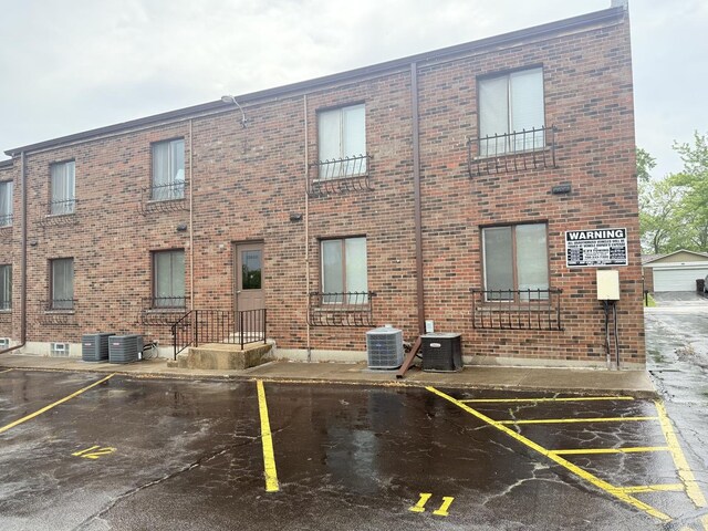22633 Pleasant Dr Unit 11B, Richton Park, IL 60471 - view of property with central AC unit and uncovered parking