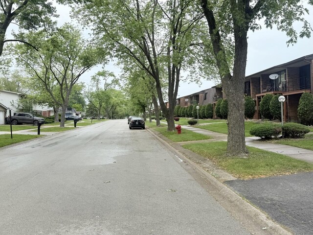 22633 Pleasant Dr Unit 11B, Richton Park, IL 60471 - view of asphalt road with curbs, sidewalks, and a residential view