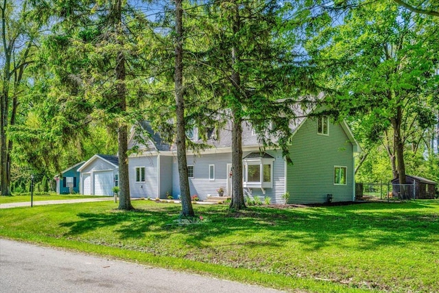 2425 W Riverside Dr, Mchenry, IL 60050 - view of front of property with a front lawn, driveway, a garage, and an outbuilding