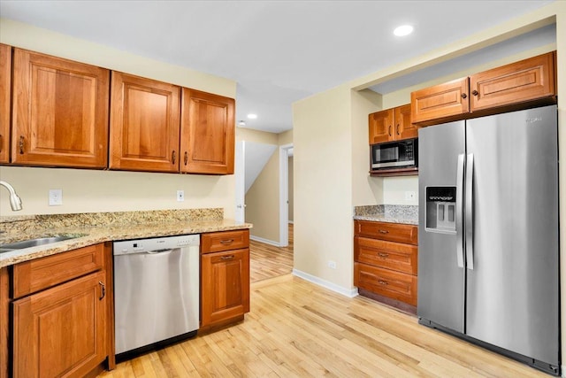 2425 W Riverside Dr, Mchenry, IL 60050 - kitchen with stainless steel appliances, a sink, light wood-style floors, brown cabinets, and recessed lighting
