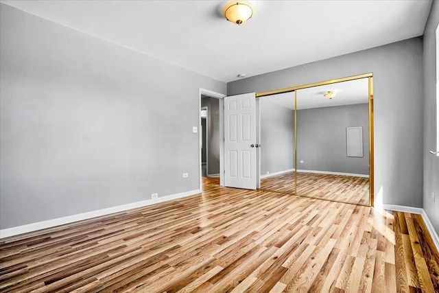 2425 W Riverside Dr, Mchenry, IL 60050 - unfurnished bedroom featuring wood finished floors, baseboards, and a closet