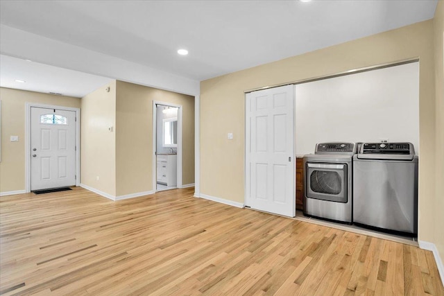 2425 W Riverside Dr, Mchenry, IL 60050 - laundry room with washing machine and dryer, light wood-type flooring, baseboards, and recessed lighting