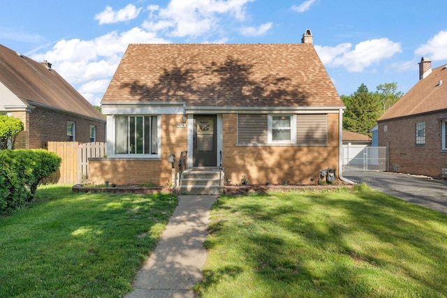 1678 State Line Rd, Calumet City, IL 60409 - cape cod-style house with brick siding, a gate, a chimney, a detached garage, and a shingled roof