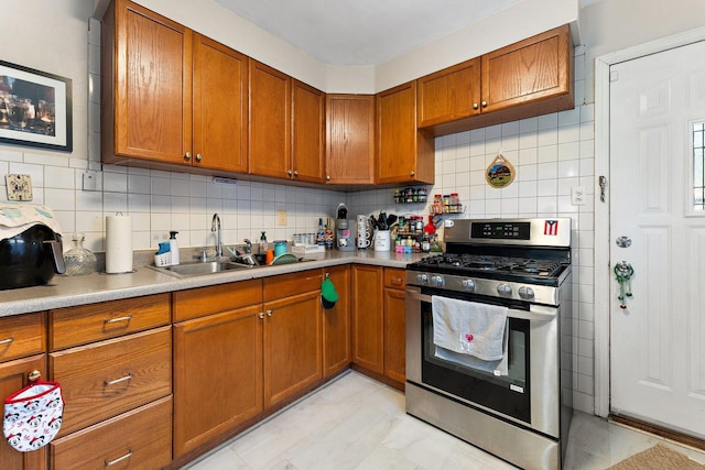 1678 State Line Rd, Calumet City, IL 60409 - kitchen with stainless steel gas range, brown cabinets, a sink, and tasteful backsplash