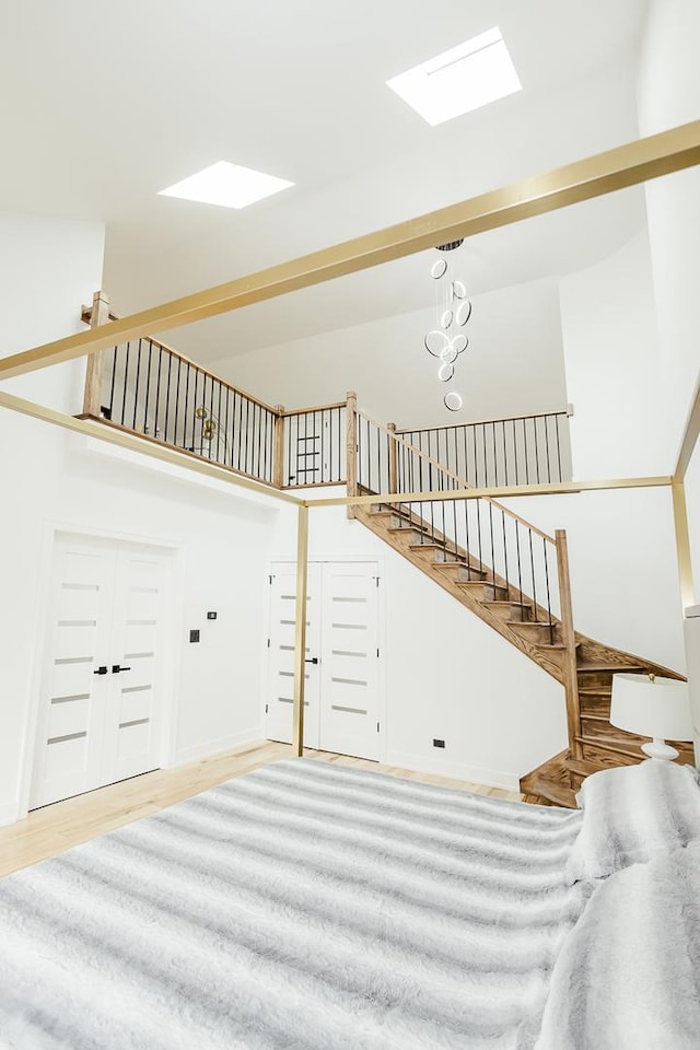 1620 Devonshire Ln, Lake Forest, IL 60045 - living area with stairs, wood finished floors, a skylight, baseboards, and a high ceiling