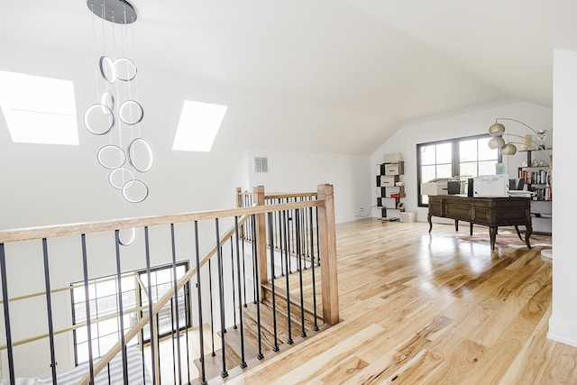 1620 Devonshire Ln, Lake Forest, IL 60045 - hall featuring a skylight, vaulted ceiling, wood finished floors, an upstairs landing, and a desk