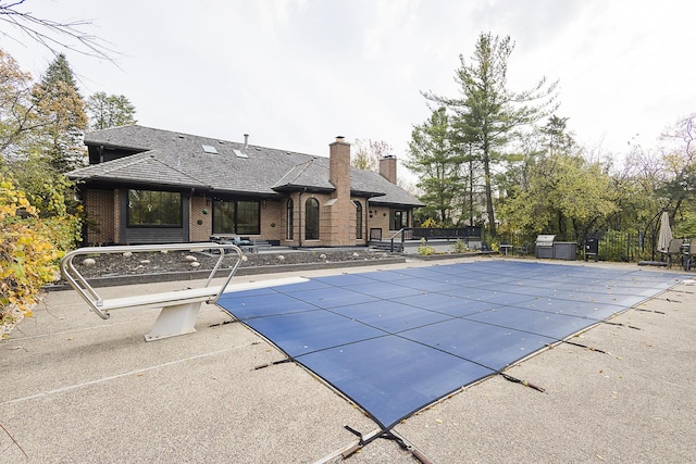 1620 Devonshire Ln, Lake Forest, IL 60045 - view of swimming pool with a diving board, a patio area, and a covered pool