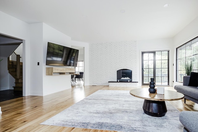 1620 Devonshire Ln, Lake Forest, IL 60045 - living area featuring a brick fireplace, stairway, and wood finished floors