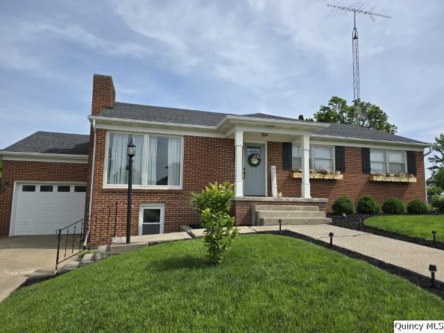 202 W Archer Ave, La Harpe, IL 62321 - view of front of house with a garage, concrete driveway, a chimney, and brick siding
