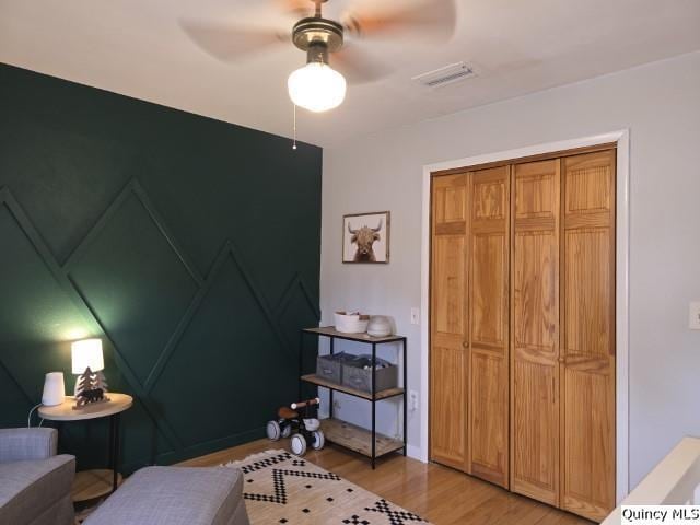 202 W Archer Ave, La Harpe, IL 62321 - bedroom featuring light wood-style floors, ceiling fan, and a closet