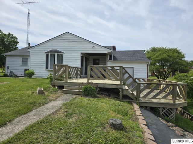 202 W Archer Ave, La Harpe, IL 62321 - back of property featuring a yard, a deck, and a shingled roof