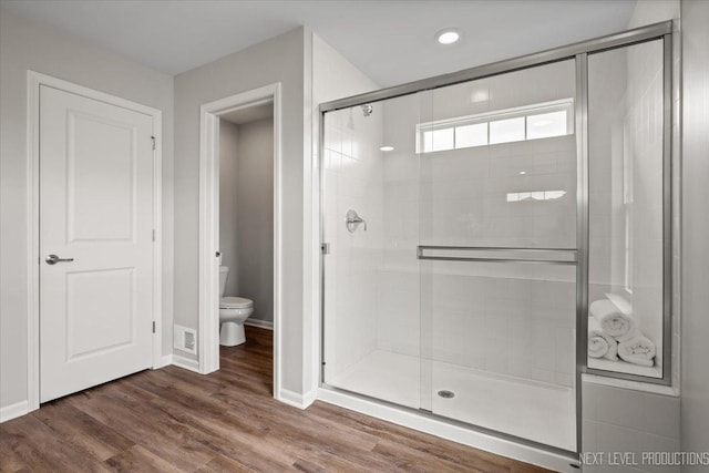 16017 S Crescent Ln, Plainfield, IL 60586 - bathroom featuring toilet, a stall shower, baseboards, and wood finished floors
