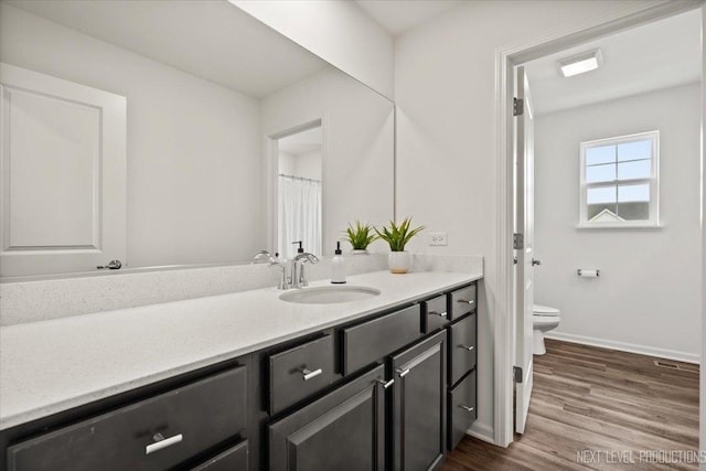 16017 S Crescent Ln, Plainfield, IL 60586 - bathroom featuring vanity, toilet, baseboards, and wood finished floors