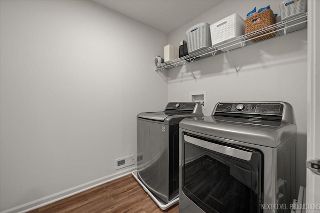 16017 S Crescent Ln, Plainfield, IL 60586 - laundry room featuring washing machine and clothes dryer, wood finished floors, and baseboards