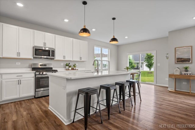 16017 S Crescent Ln, Plainfield, IL 60586 - kitchen with appliances with stainless steel finishes, dark wood finished floors, a sink, white cabinets, and recessed lighting