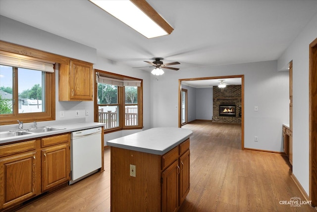 1345 William St, Sycamore, IL 60178 - kitchen with dishwasher, light wood finished floors, a center island, a fireplace, and light countertops