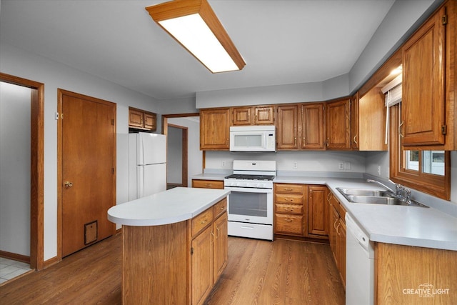 1345 William St, Sycamore, IL 60178 - kitchen featuring white appliances, light countertops, light wood-style flooring, and brown cabinets
