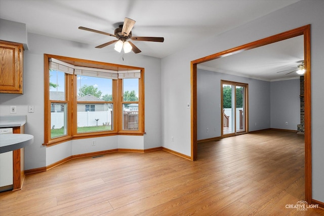 1345 William St, Sycamore, IL 60178 - unfurnished living room featuring ceiling fan, light wood-style flooring, and ornamental molding