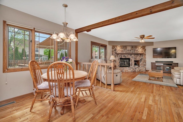 910 N Dovington Dr, Hoffman Estates, IL 60169 - dining space with light wood-style flooring, a chandelier, healthy amount of natural light, a fireplace, and beamed ceiling