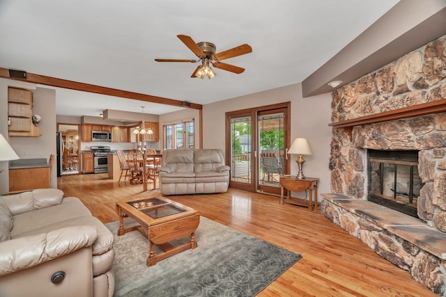 910 N Dovington Dr, Hoffman Estates, IL 60169 - living room featuring a fireplace, ceiling fan, light wood-type flooring, and a chandelier