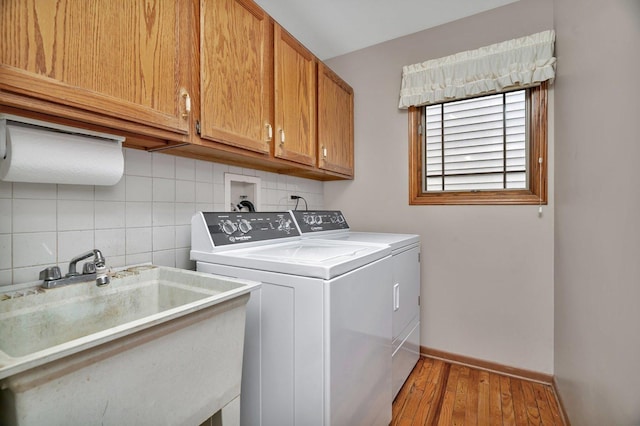 910 N Dovington Dr, Hoffman Estates, IL 60169 - washroom featuring washing machine and clothes dryer, cabinet space, light wood-style floors, and baseboards