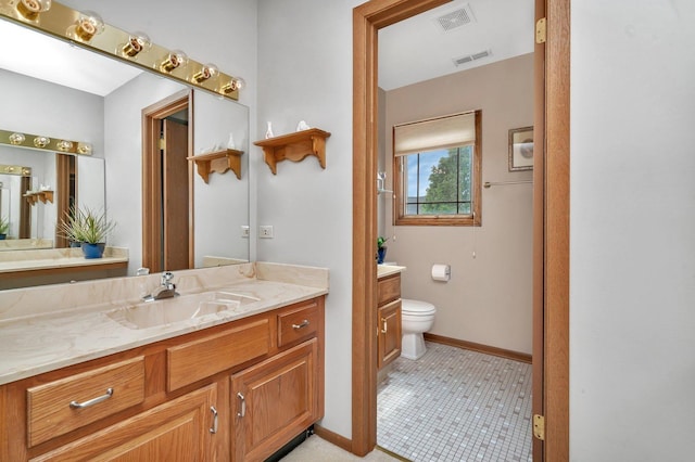 910 N Dovington Dr, Hoffman Estates, IL 60169 - bathroom with vanity, toilet, baseboards, and tile patterned flooring