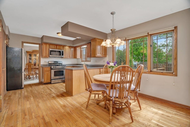 910 N Dovington Dr, Hoffman Estates, IL 60169 - dining room with a chandelier, light wood-style floors, and baseboards