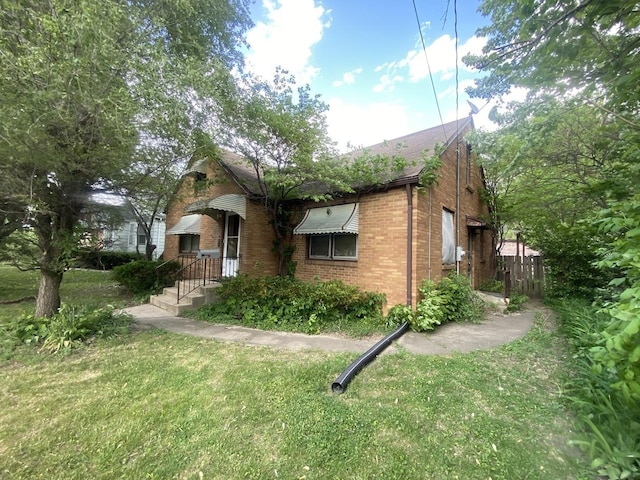 920 16th St, Rockford, IL 61104 - view of side of property with brick siding and a lawn