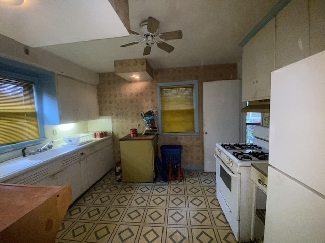 920 16th St, Rockford, IL 61104 - kitchen featuring white appliances, ceiling fan, a sink, and light floors