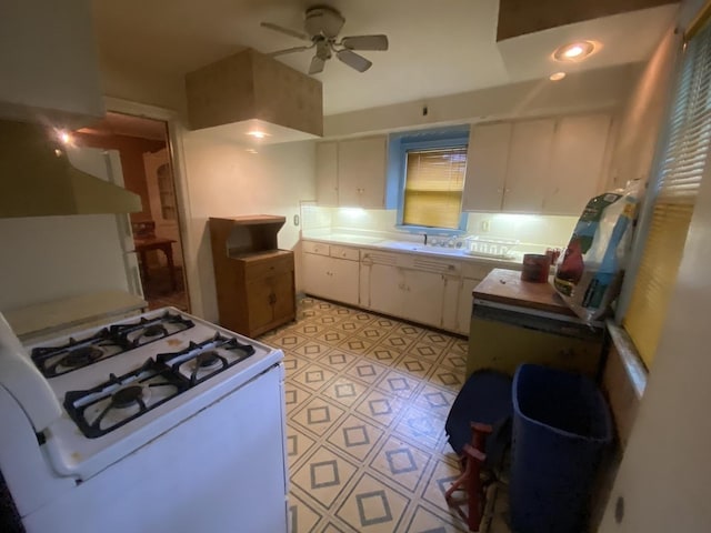 920 16th St, Rockford, IL 61104 - kitchen featuring gas range gas stove, ceiling fan, white cabinetry, a sink, and light countertops